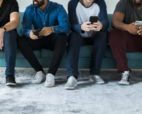 Group of diverse men using mobile phone social media and internet concept Group of diverse men using mobile phone social media and internet concept